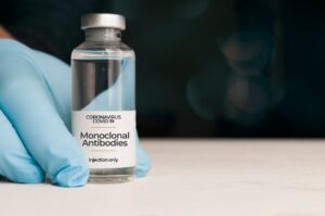 monoclonal antibody vial and medical glove holding it